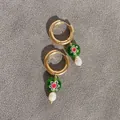 Detail of gold hoop earrings with green floral glass beads and white baroque pearls - Green Flower Glass Bead with Baroque Pearl Style