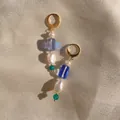 Detail of beaded drop earring with baroque pearl and colorful stones on champagne fabric - Purple Cube Glass Bead with Baroque Pearl Style