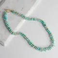 Detalle de collar de cuentas turquesas con cierre de barra dorado sobre mármol - Collar F / Talla única / 43cm / Verde azulado
