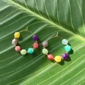 Colorful natural stone beaded hoop earrings on a tropical green leaf in sunlight - Multicolor Faceted Cut Bead Hoop Style
