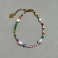 Colorful glass bead bracelet with fresh pearls and golden heart pendant on grey background - Multicolor Seed Bead Blue Stripe Heart Pendant Style (5)