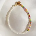 Detailed shot of glass beads and natural pearls bracelet on white silk background - Colorful Striped Glass Bead Splicing Style (6)