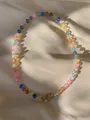 Macro detail of natural stones and pearls necklace with golden clasp on silk background - Multicolor Frosted Bead Style (3)
