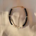 Detailed close-up of baroque pearls and black beads on an elegant gold link chain - Black Agate Texture Pearl Style (6)
