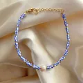 Detail of beaded bracelet with blue-white stripes, pearl center, and gold clasp - Blue White Stripe Bead Center Pearl Style (14)
