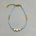 Detailed view of colorful glass beads and freshwater pearls on an adjustable bracelet - Blue Purple Seed Bead Triple Pearl Contrast Style (18)
