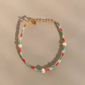 Detailed shot of handmade colorful beaded bracelet with white pearls and gold hardware - Red Green Blue Multicolor Baroque Pearl Style (29)