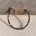 Detail of faceted grey natural stone beads and golden lobster clasp on handmade bracelet - Labradorite Texture Black Style (21)