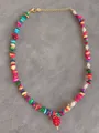 Close-up of vibrant beaded necklace with natural stones, pearls and a red strawberry charm - Colorful Stone Strawberry Pendant Style (19)