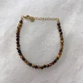 Macro view of beaded bracelet with tiger eye stones and gold lobster clasp detail - Tiger Eye Cat's Eye Effect Round Bead Style (33)
