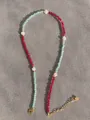 Beaded necklace with red and light blue faceted gems and pearls on grey background - Red Blue Minimalist Style (39)