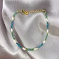Detail of freshwater pearl and gemstone bracelet with golden lobster clasp and silk background - Green Blue Faceted Gemstone Freshwater Pearl Style (35)