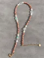 Macro view of natural stone, freshwater pearls, and petal beads on a beaded necklace - Pink Orange Stone Fantasy Petal Style (32)