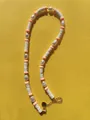 Detail of beaded necklace with freshwater pearls, heishi beads and golden heart clasp - White Ceramic-Look PVC Heart Plaque Style with Orange Patterned Beads (36)