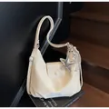 Chic beige moon shoulder bag with glossy finish and star and balloon dog charms - With Pendant / Off White