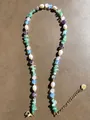 Detailed shot of natural stones and freshwater pearls with a gold heart pendant charm - Multicolor Stone Pearl Heart Pendant Style (42)
