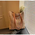 Detail of hand-woven straw bag with geometric patterns and brown leather straps - Khaki