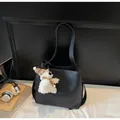 Minimalist black PU leather bucket bag with a cute white plush doll charm accessory - With Pendant / Black