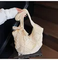 Handmade crochet shoulder bag in beige with hollow floral pattern and bow detail - One Size / Off White