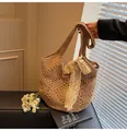 Handwoven straw tote bag with lace bow decoration and hollow flower pattern in natural tan - One Size / Khaki