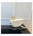 Minimalist white leather saddle handbag with signature gold knot metal ring handle - White / One Size