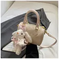 Creamy white printed Boston bag with litchi texture and cute plush rabbit charm - Pink Animal Embossed Style And White Plush Bunny Pendant
