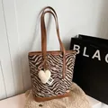 Zebra print velvet bucket bag with brown leather straps and a white heart plush charm - With Pendant / Zebra Print