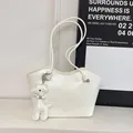 Chic beige wrinkled patent leather tote bag with a cute giraffe charm and knotted strap - White