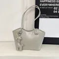 Minimalist light gray tote bag with a matching giraffe leather charm accessory - Gray