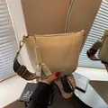 Beige bucket bag with textured leather and a vintage ethnic woven wide shoulder strap - One Size / Off White