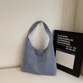 Minimalist light blue denim hobo shoulder bag with a crescent shape for casual commuting - Light Blue