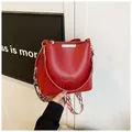 Red leather bucket bag with geometric wide strap and gold hardware accents - One Size / Red