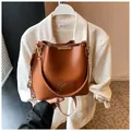 Brown vintage leather bucket bag with wide geometric woven strap and gold hardware - One Size / Brown