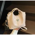 Minimalist beige faux leather tote bag with pleated detail and metal logo on stairs - One Size / Off White