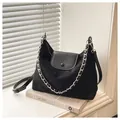 Detail of black suede tote bag with silver chain strap and leather flap closure - Black