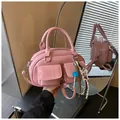 Detailed close-up of pink Boston bag with glossy leather finish and cute teddy bear charm - No Pendant / Pink