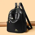 Minimalist black faux leather backpack featuring gold heart zippers and a roomy design - One Size / Black