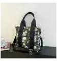 Large travel tote bag featuring skull and white floral print with adjustable strap - Yellow