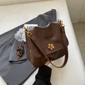 Dark brown retro crossbody bag with golden flower lock and textured vegan leather - Coffee