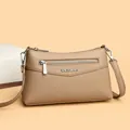 Light brown cross-body bag with pebble grain leather texture and metal brand plaque - One Size / Khaki
