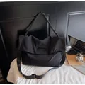Close-up of black nylon tote bag featuring braided handle and adjustable shoulder strap - One Size / Black