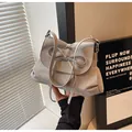 Detail of grey PU leather shoulder bag featuring a stylish decorative bow and pleated texture - One Size / Light Gray