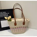 Detailed view of woven straw tote bag featuring colorful wave patterns and leather straps - One Size / Cream with Pink
