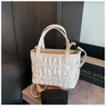 Detail of cream quilted leather handbag featuring sparkling rhinestones and double handles - White