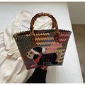 Handmade woven tote bag with a cute sausage dog patch and rustic bamboo-style handle - Black Dog