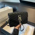 Black quilted crossbody bag with chevron pattern, gold chain strap and fringe tassel charm - Black