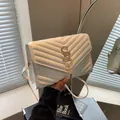 White quilted crossbody bag with golden V-pattern and elegant metal tassel detail - Off White