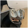 Silver metallic chain bag with 3D butterfly accent and cloud-shaped drawstring design - Silver