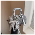 Silver denim-style Boston bag with rhinestone quilted pattern and pearl bow charm - With Pendant / Silver