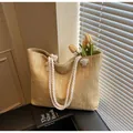 Straw tote bag with white rope handles and decorative tassels in a natural beige finish - One Size / Khaki